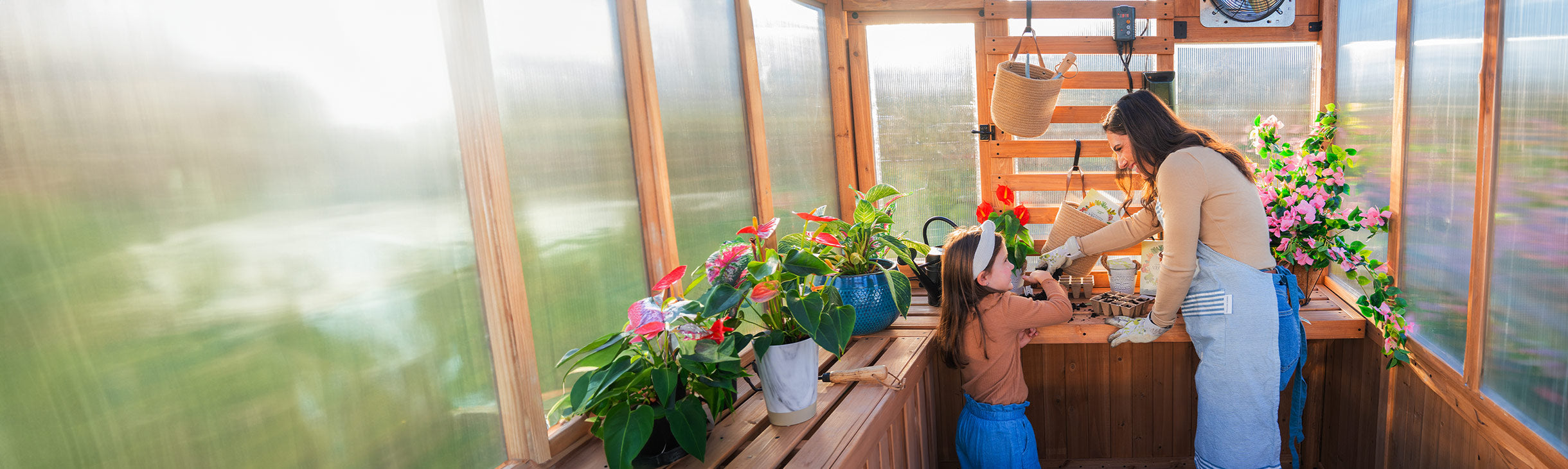 mom and daughter in greenhouse