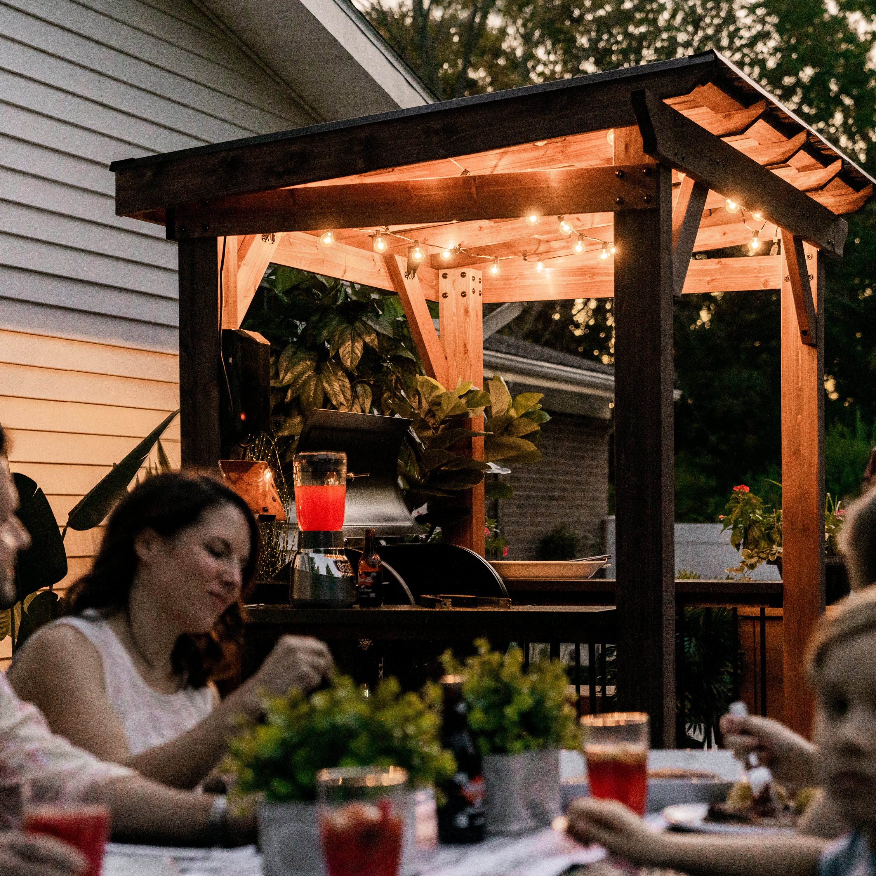 Saxony Grill Gazebo placed on deck for outdoor dinner party