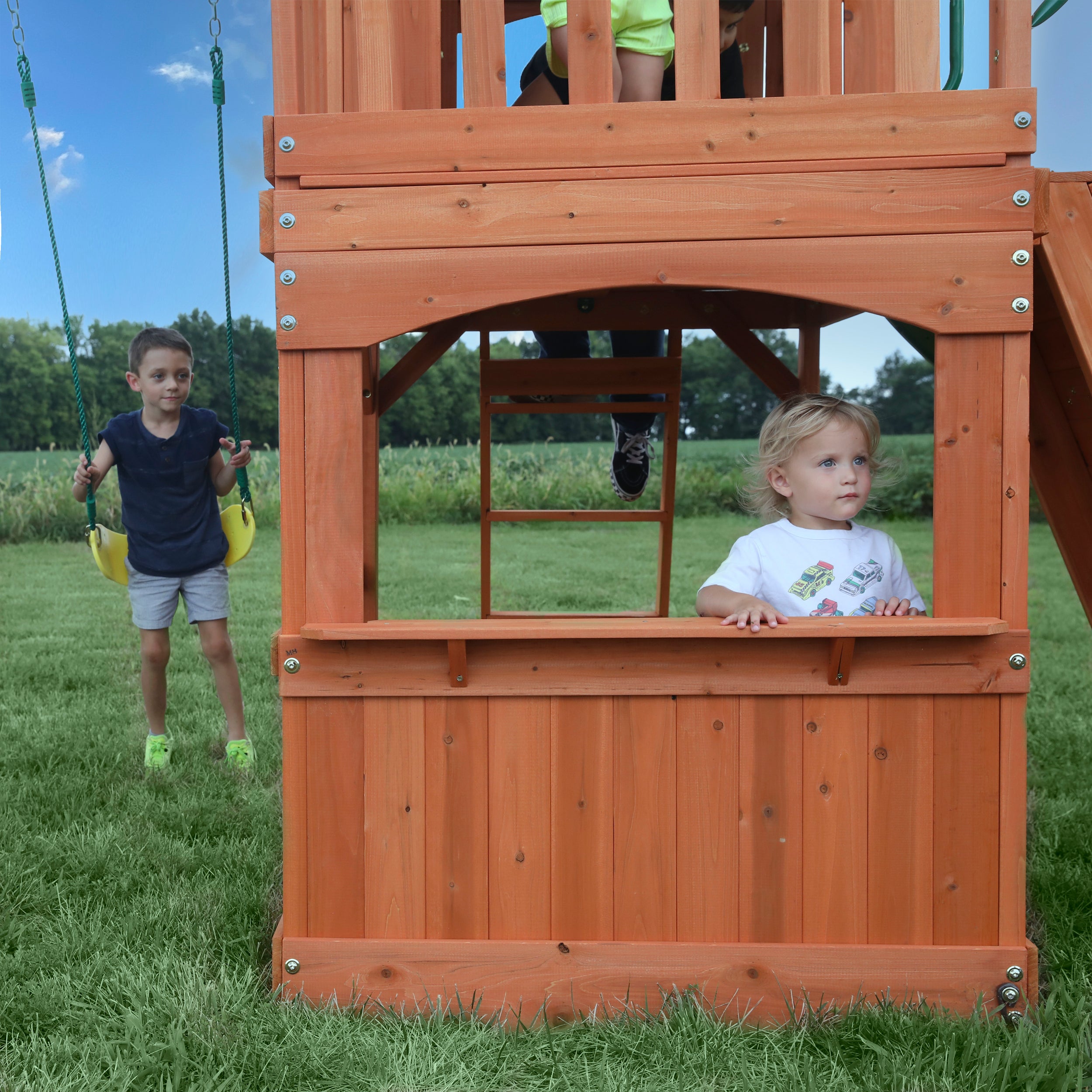 Young girl in swing set clubhouse